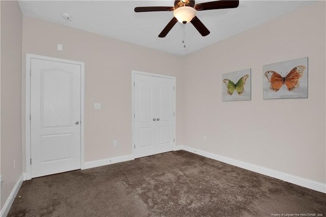 unfurnished bedroom featuring dark carpet and ceiling fan