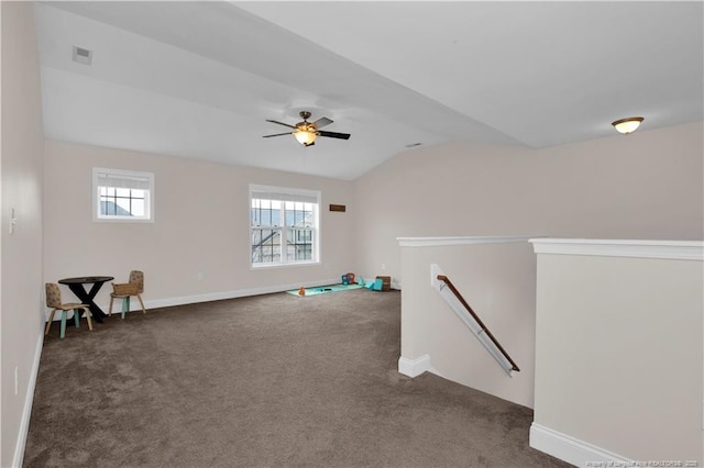 carpeted empty room featuring vaulted ceiling and ceiling fan