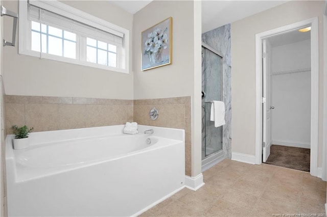 bathroom with tile patterned floors and plus walk in shower