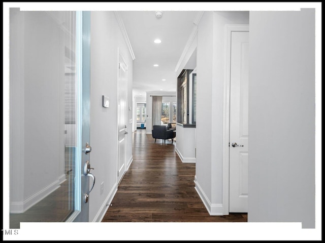 hall featuring dark wood finished floors, recessed lighting, crown molding, and baseboards