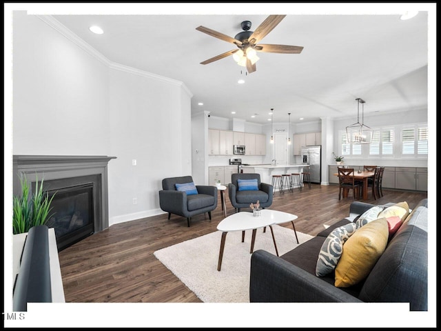 living area featuring a glass covered fireplace, dark wood-style floors, and recessed lighting