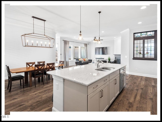 kitchen with plenty of natural light, ornamental molding, stainless steel dishwasher, and a sink