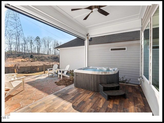 wooden terrace featuring a patio area, a hot tub, ceiling fan, and fence