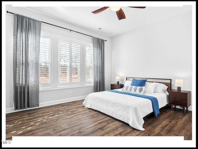 bedroom featuring baseboards, wood finished floors, and a ceiling fan