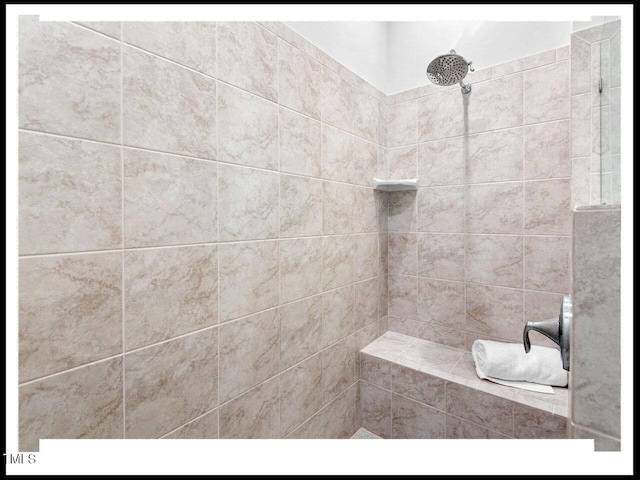 bathroom with tiled shower