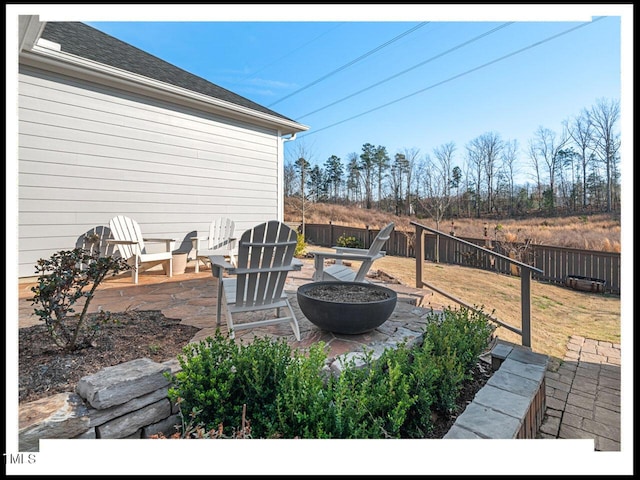 view of patio / terrace featuring fence and an outdoor fire pit