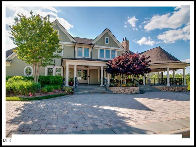 craftsman-style home with french doors, covered porch, and board and batten siding