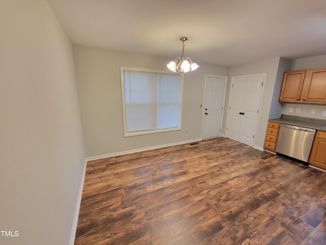 kitchen featuring dishwasher, dark wood-type flooring, pendant lighting, and a chandelier