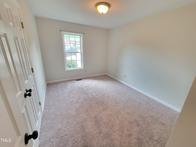 unfurnished room with light carpet