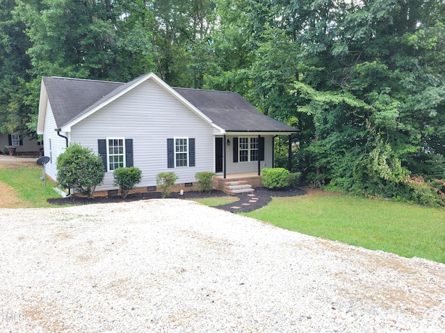 ranch-style house featuring a front yard and covered porch