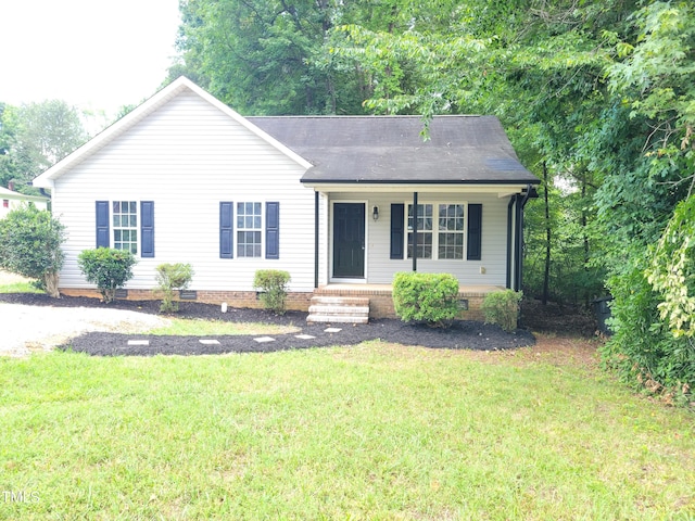 single story home featuring covered porch and a front yard