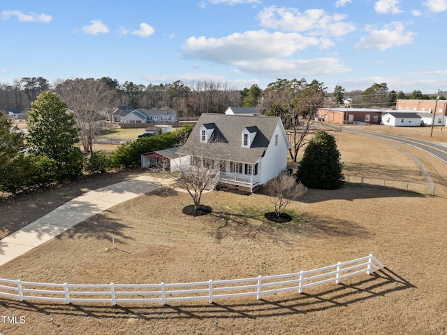 view of front of property with a fenced front yard and a rural view