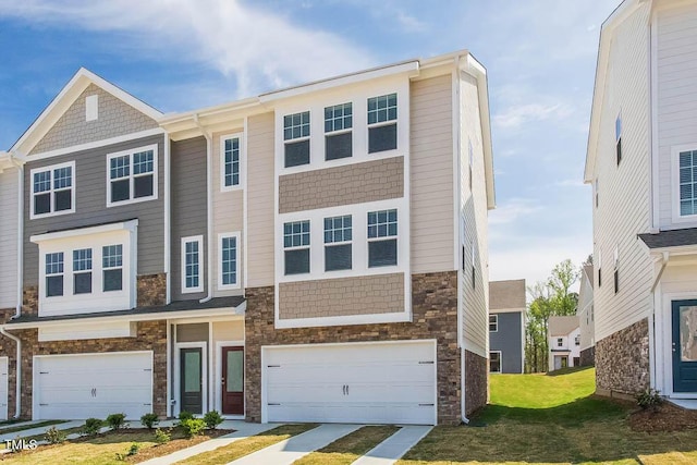 townhome / multi-family property featuring a garage and a front lawn