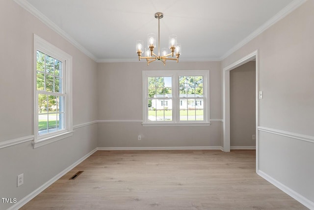 unfurnished room with ornamental molding, a chandelier, and light hardwood / wood-style floors