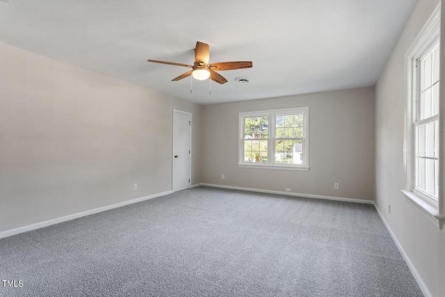 carpeted empty room featuring ceiling fan