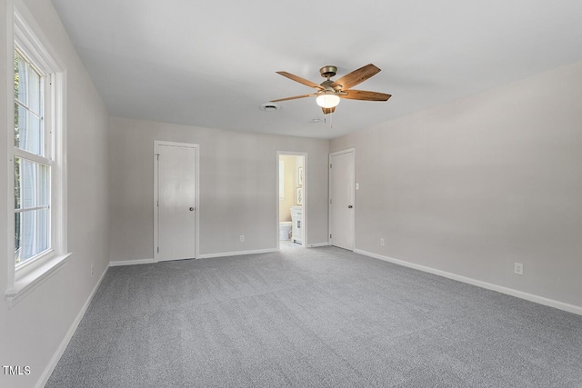 unfurnished room featuring ceiling fan and carpet