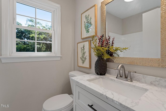 bathroom featuring vanity and toilet