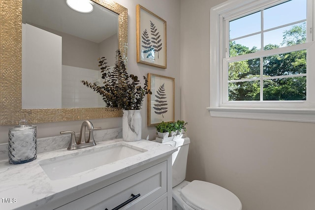 bathroom featuring vanity and toilet