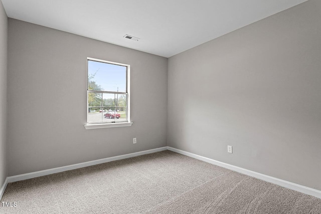 carpeted empty room with baseboards and visible vents