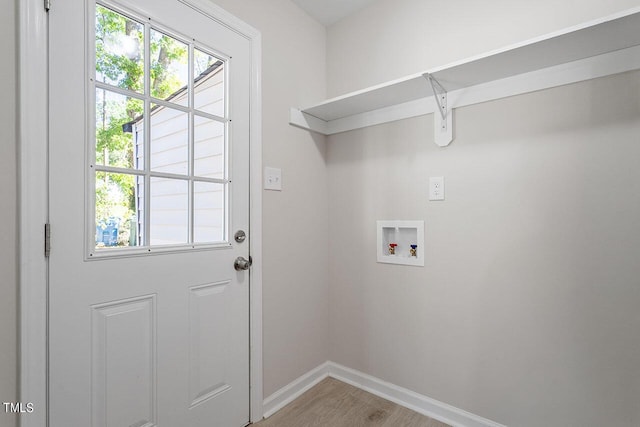 laundry room with washer hookup and hardwood / wood-style floors