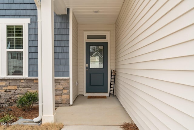 entrance to property with stone siding