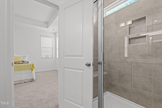 bathroom featuring a stall shower and baseboards