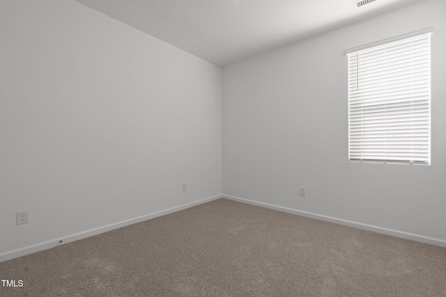 unfurnished room featuring carpet flooring and baseboards