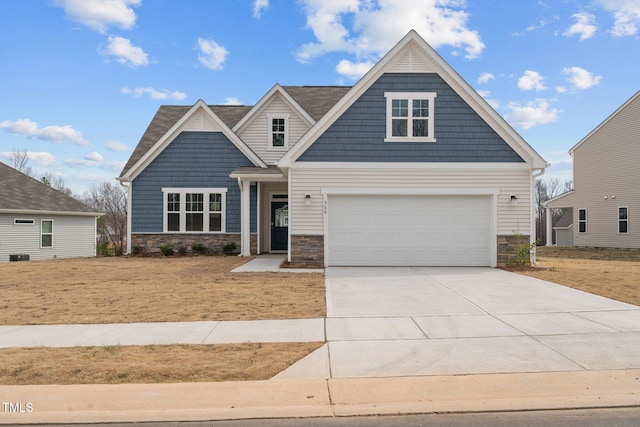 craftsman-style house featuring driveway and stone siding