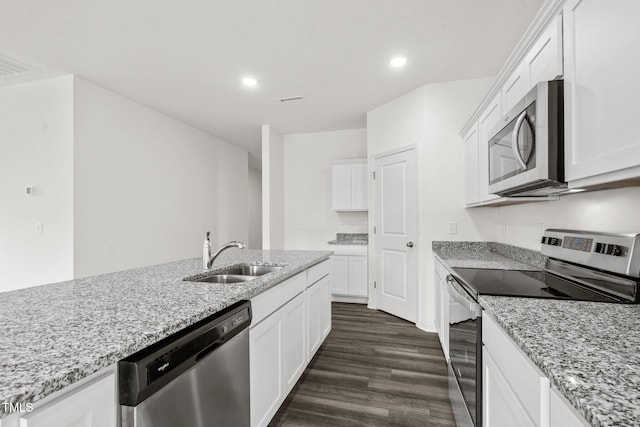 kitchen featuring light stone countertops, appliances with stainless steel finishes, sink, and white cabinets