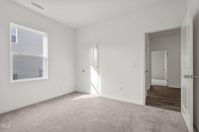 unfurnished bedroom featuring dark carpet