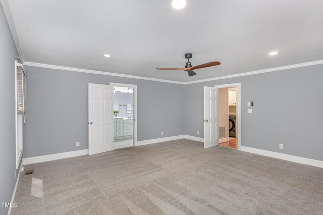 unfurnished bedroom with carpet flooring, washer / clothes dryer, baseboards, and ornamental molding