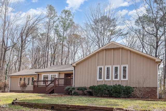 single story home featuring a front yard, crawl space, roof with shingles, and a wooden deck