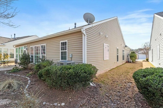 view of side of property featuring an outbuilding