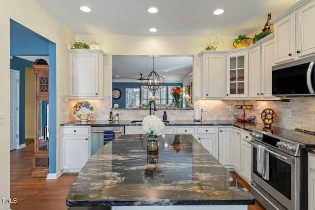 kitchen featuring beverage cooler, dark wood finished floors, white cabinetry, stainless steel electric range oven, and a chandelier