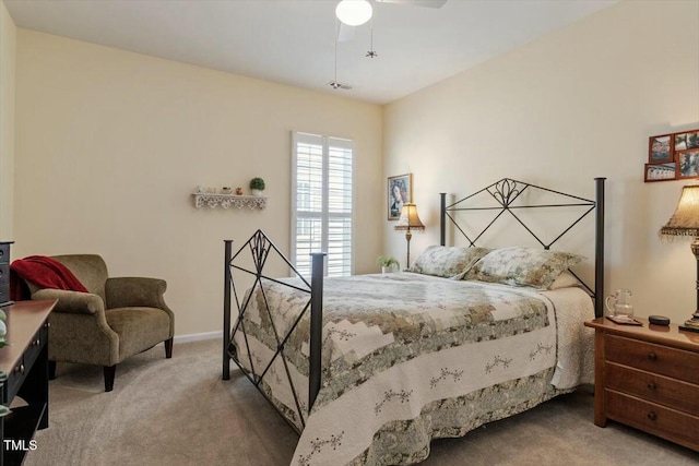 carpeted bedroom featuring baseboards and a ceiling fan