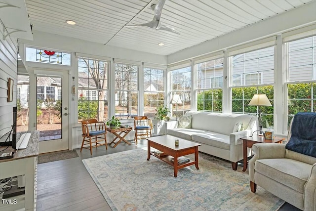 sunroom / solarium featuring wooden ceiling and ceiling fan