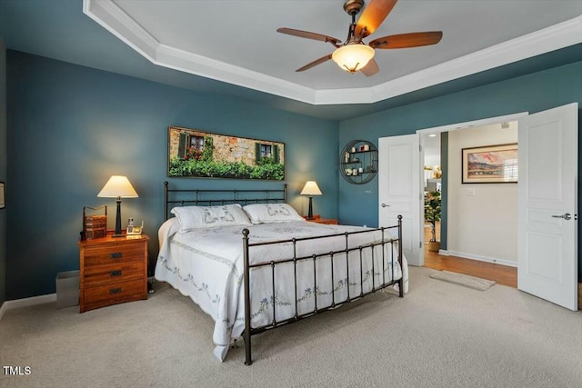 bedroom featuring carpet flooring, baseboards, and a tray ceiling