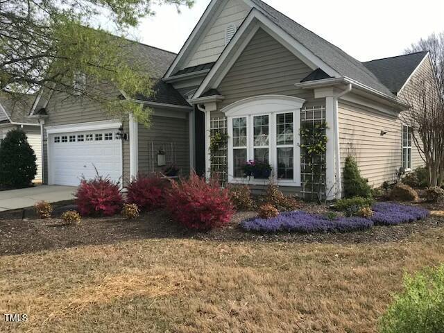 view of front of property featuring concrete driveway and a garage