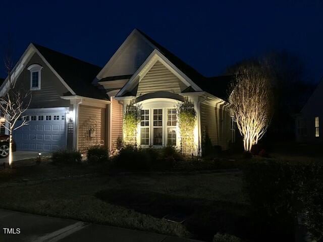 view of front of property featuring concrete driveway and an attached garage