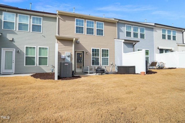 back of house with a lawn and central air condition unit