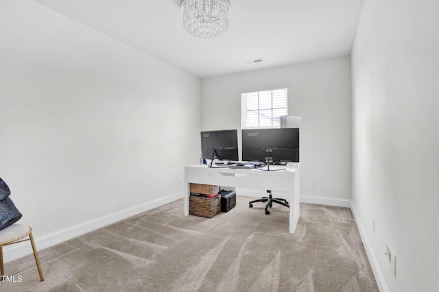 office space with light carpet and a notable chandelier