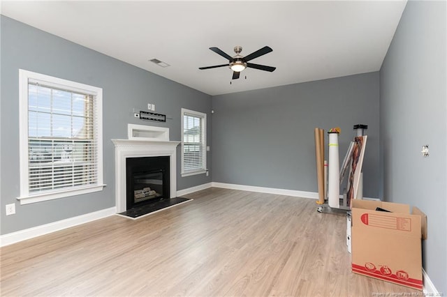 living room with ceiling fan and light hardwood / wood-style flooring