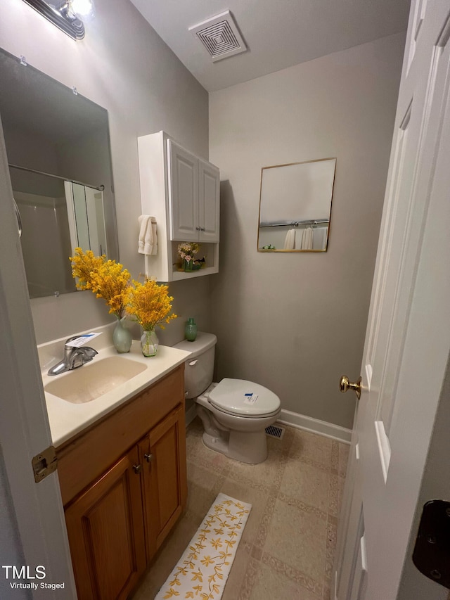 bathroom featuring walk in shower, vanity, and toilet