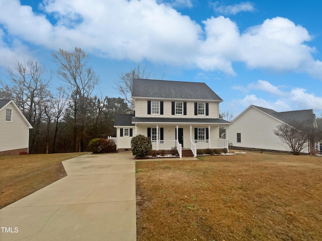 view of front of house with a front yard, covered porch, driveway, and crawl space