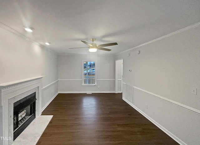 unfurnished living room with ornamental molding, a high end fireplace, and dark wood-style flooring