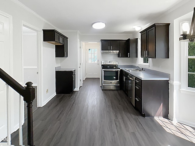 1599 Rogers Pointe Ln, Creedmoor, NC 27522 - kitchen with appliances with stainless steel finishes, under cabinet range hood, dark wood-type flooring, light countertops, and ornamental molding