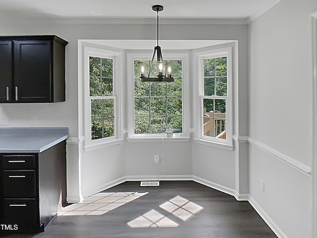 1599 Rogers Pointe Ln, Creedmoor, NC 27522 - unfurnished dining area with dark wood-type flooring, a chandelier, and crown molding