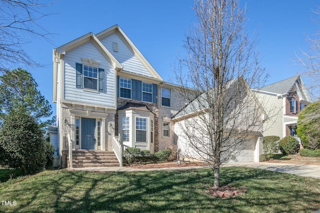 traditional-style home with a garage, a front yard, concrete driveway, and brick siding