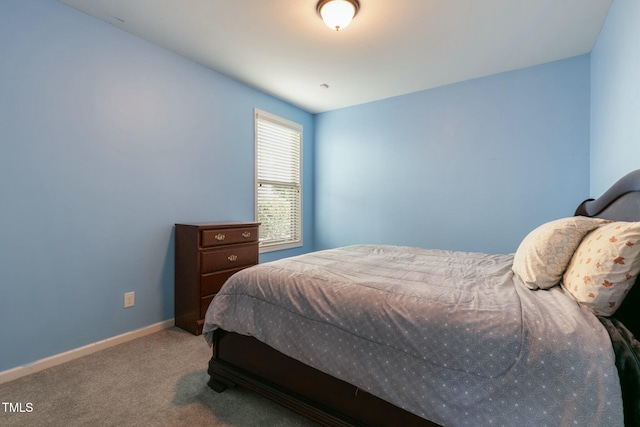 bedroom with carpet flooring and baseboards