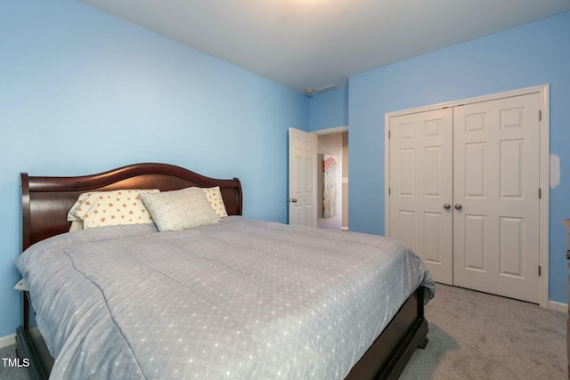 bedroom with a closet, carpet, and baseboards